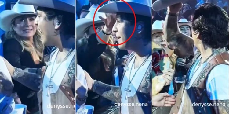 Christian Nodal regaña a fan que le quiso robar el sombrero.